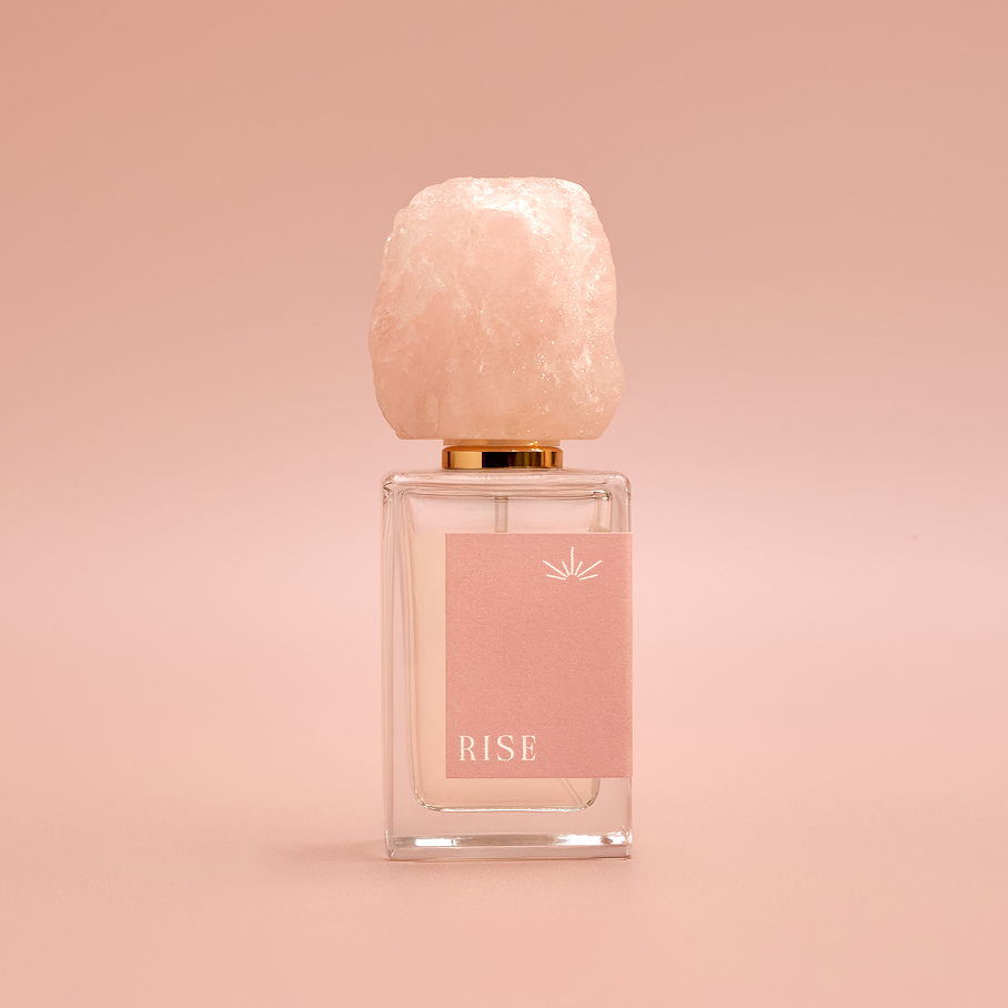 RISE eau de parfum bottle with its rose quartz cap