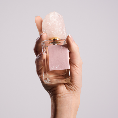RISE eau de parfum bottle, rose quartz cap seen close up